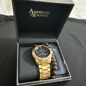 American Exchange Gold Tone Watch with Black Dial and Brown Bead Accent